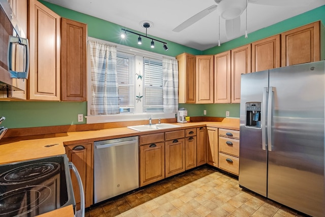 kitchen with rail lighting, ceiling fan, sink, and appliances with stainless steel finishes