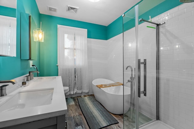 full bathroom with vanity, separate shower and tub, hardwood / wood-style flooring, and toilet