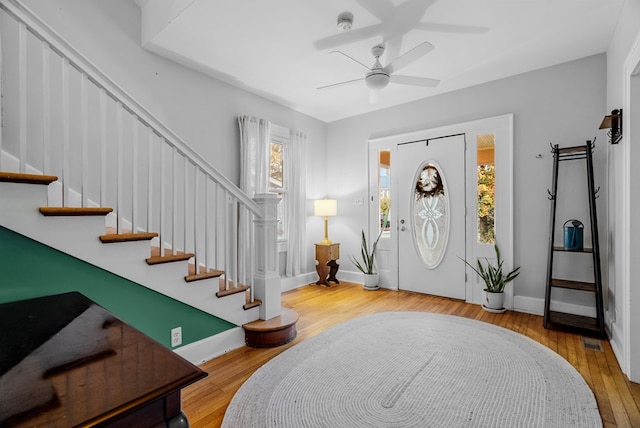 foyer with ceiling fan and light wood-type flooring