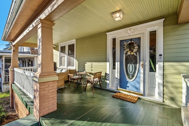 view of exterior entry featuring a porch