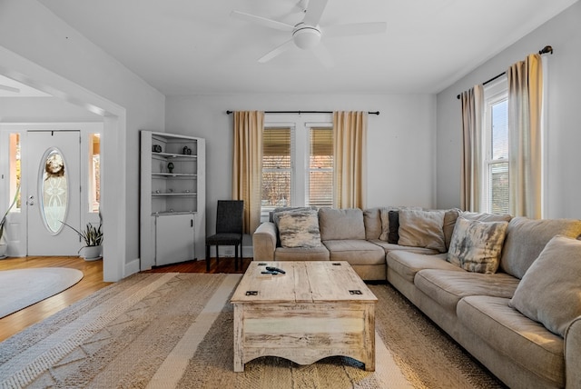 living room with hardwood / wood-style floors and ceiling fan