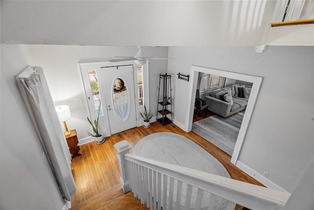 entryway featuring ceiling fan, light hardwood / wood-style floors, and vaulted ceiling