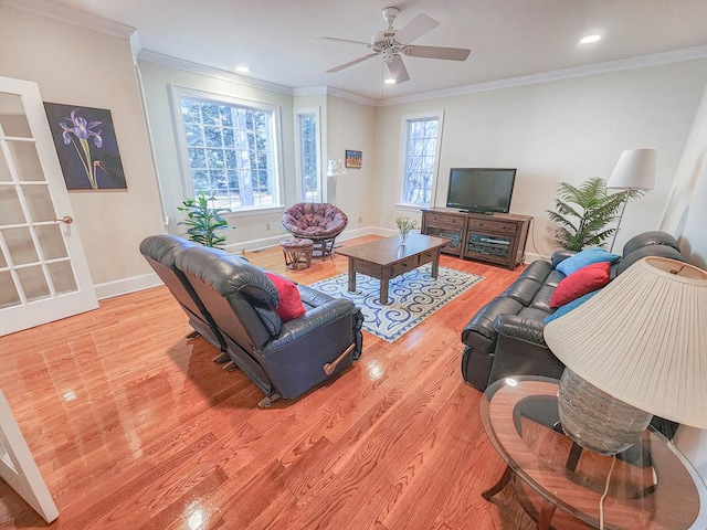 living room with crown molding, ceiling fan, and light hardwood / wood-style flooring