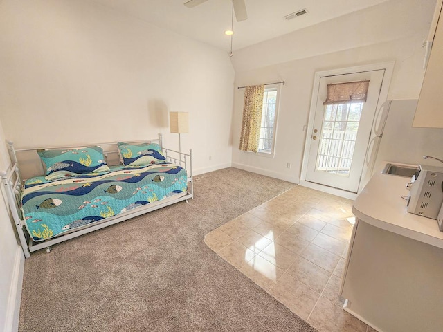 unfurnished bedroom with access to exterior, light colored carpet, sink, and ceiling fan