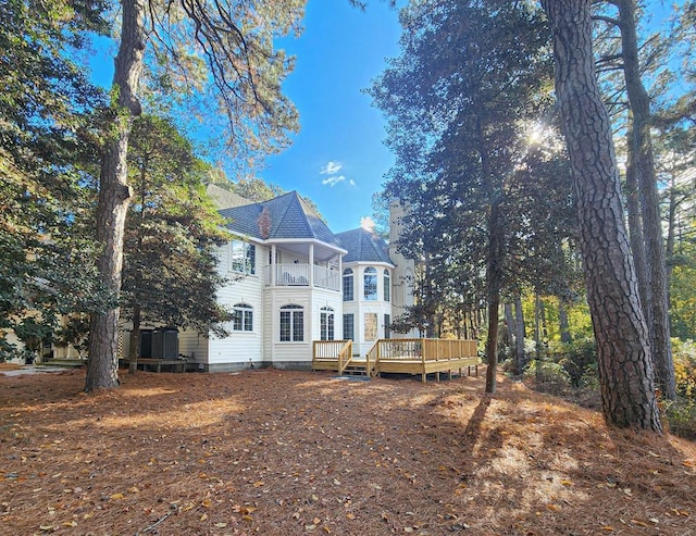 rear view of property with a wooden deck