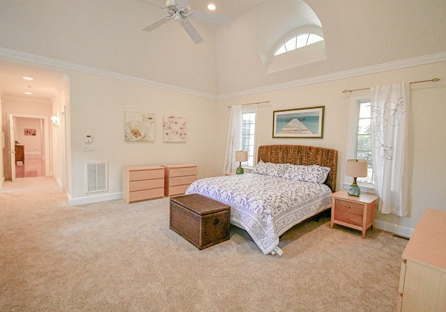 carpeted bedroom with ceiling fan, ornamental molding, and multiple windows