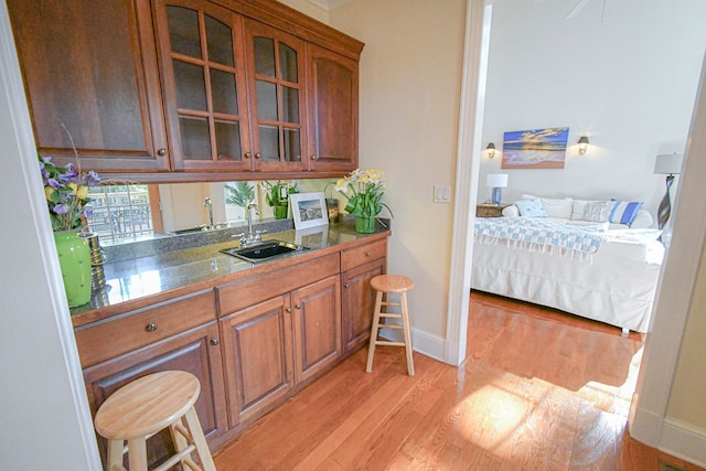 kitchen with sink and light hardwood / wood-style flooring