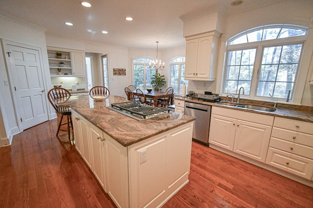 kitchen featuring a kitchen island, appliances with stainless steel finishes, pendant lighting, white cabinets, and dark wood-type flooring