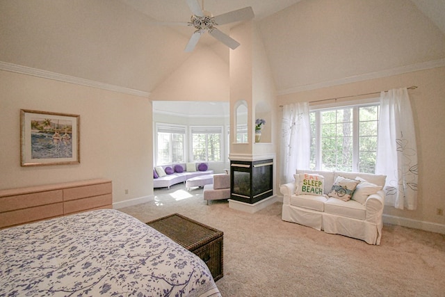 carpeted bedroom with high vaulted ceiling, ornamental molding, ceiling fan, and a multi sided fireplace