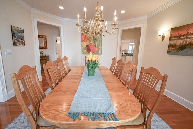 dining area with ornamental molding, a chandelier, and hardwood / wood-style floors