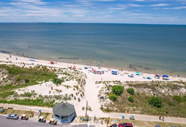 birds eye view of property featuring a water view and a beach view