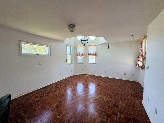 spare room with dark parquet flooring