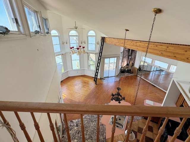 unfurnished living room featuring high vaulted ceiling and hardwood / wood-style floors