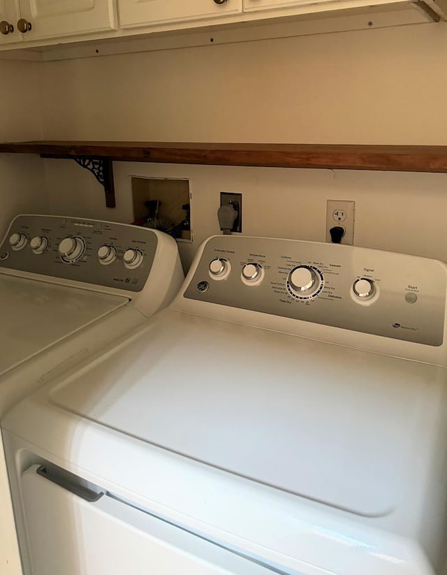 laundry room featuring cabinets and separate washer and dryer