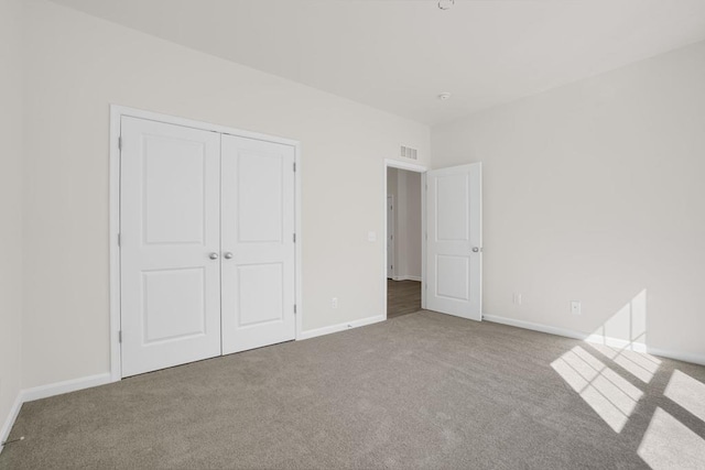 unfurnished bedroom with a closet and carpet