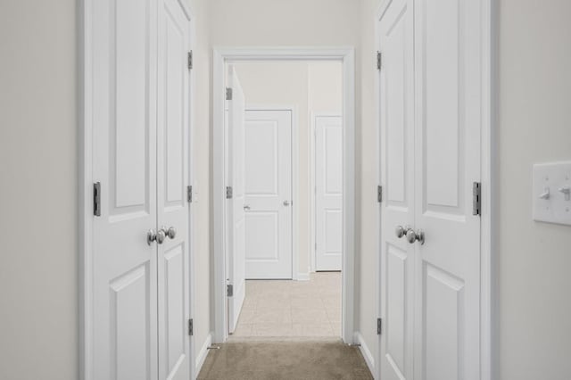 hall featuring light colored carpet