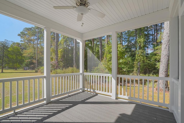 unfurnished sunroom with ceiling fan