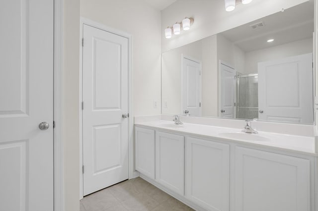 bathroom with vanity, tile patterned floors, and a shower with shower door