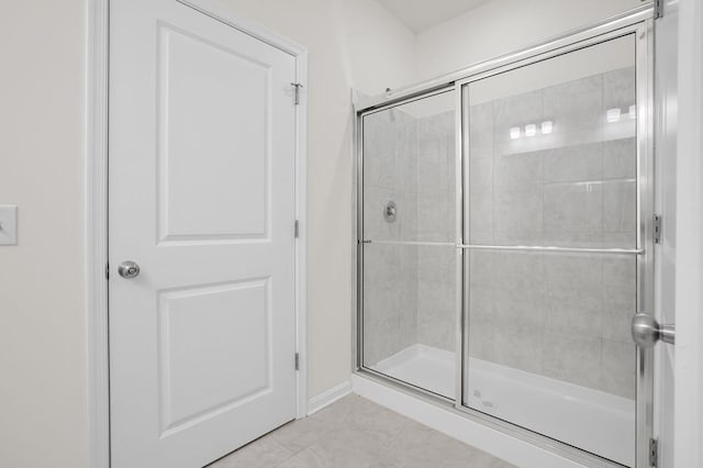 bathroom with tile patterned flooring and an enclosed shower