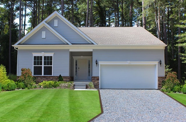 view of front of home featuring a front yard and a garage