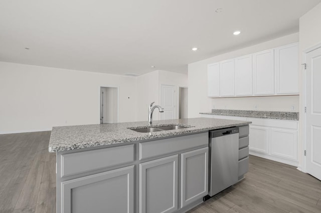 kitchen featuring white cabinetry, dishwasher, an island with sink, and sink