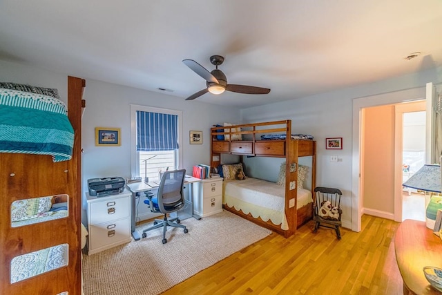 bedroom featuring visible vents, ceiling fan, light wood-style flooring, and baseboards