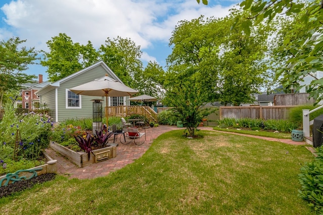 view of yard with a garden, fence, and a patio