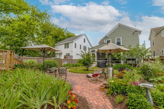 back of property featuring a patio and fence