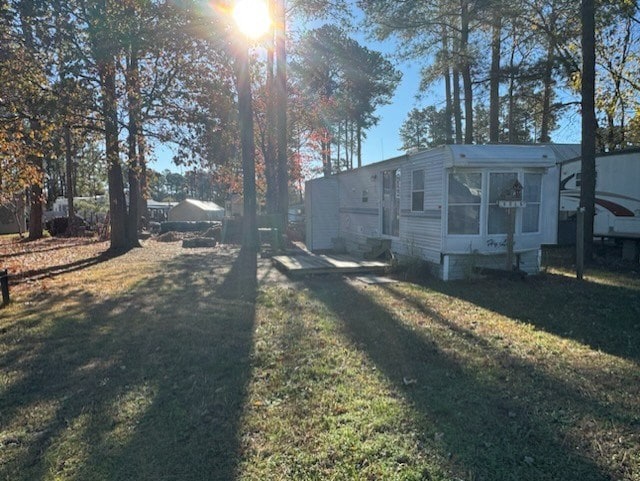 view of side of property with a yard