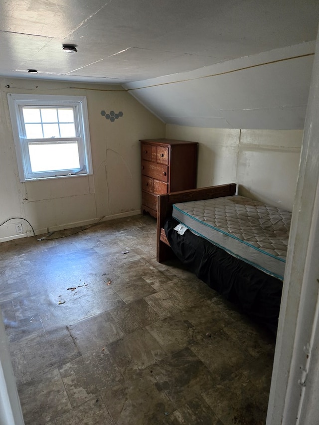 unfurnished bedroom with vaulted ceiling