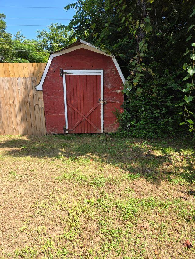 view of outbuilding with a lawn