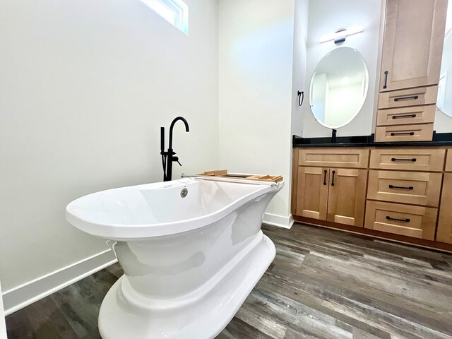 37734 Blue Crab Cir, Painter, VA 23420 - full bath with a soaking tub, vanity, baseboards, and wood finished floors