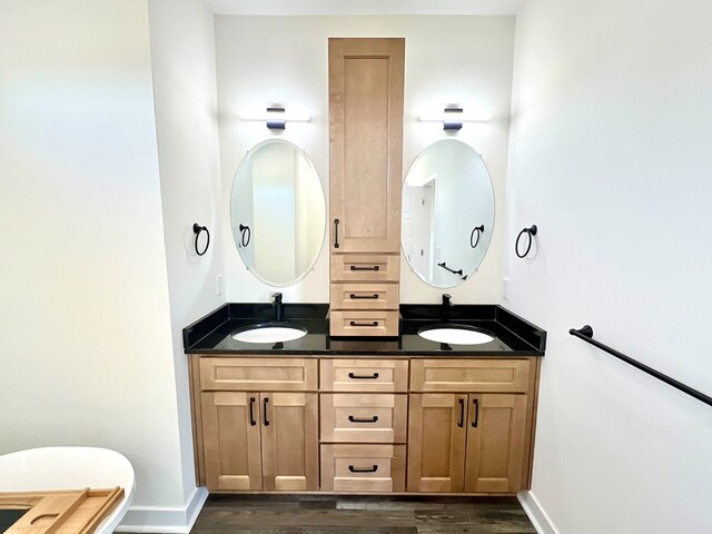 37734 Blue Crab Cir, Painter, VA 23420 - bathroom with baseboards, a sink, and wood finished floors