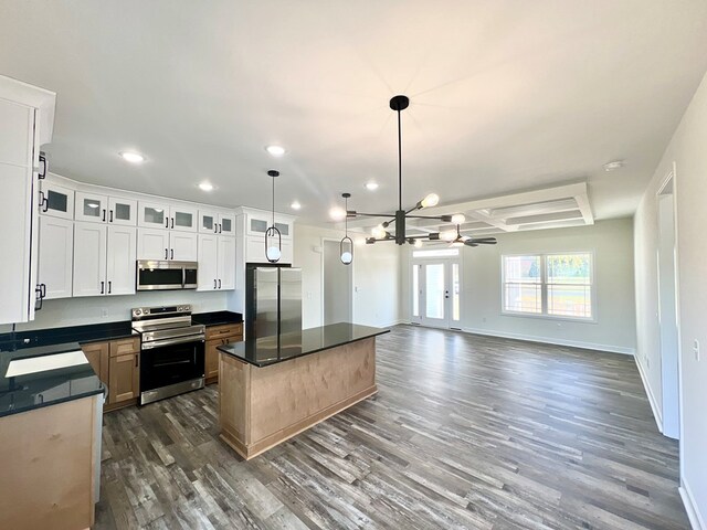 37734 Blue Crab Cir, Painter, VA 23420 - kitchen with an inviting chandelier, a kitchen island, dark countertops, dark wood-style floors, and appliances with stainless steel finishes