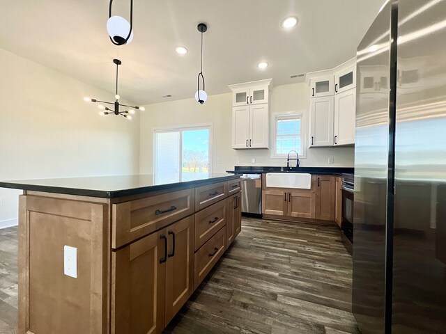 37734 Blue Crab Cir, Painter, VA 23420 - kitchen with dark wood-style flooring, visible vents, stainless steel appliances, dark countertops, and a sink