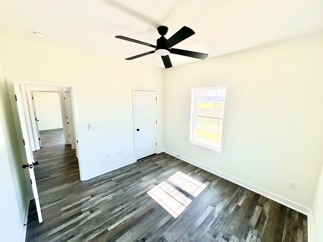 37734 Blue Crab Cir, Painter, VA 23420 - unfurnished bedroom with dark wood finished floors, baseboards, and a ceiling fan
