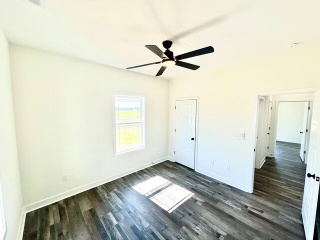 37734 Blue Crab Cir, Painter, VA 23420 - unfurnished bedroom featuring dark wood-type flooring, ceiling fan, and baseboards