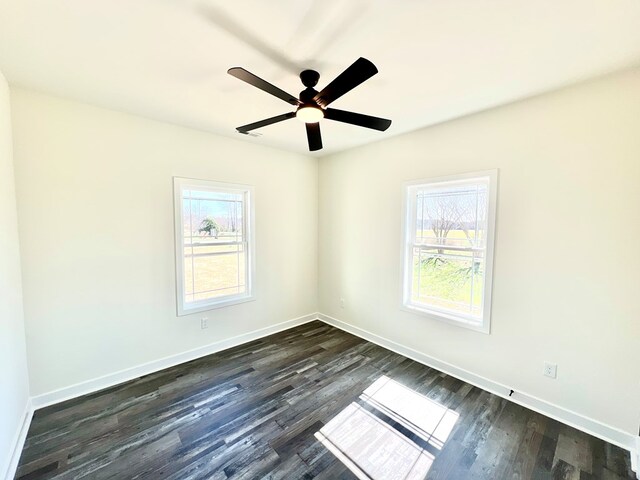 37734 Blue Crab Cir, Painter, VA 23420 - unfurnished room with dark wood finished floors, baseboards, and a ceiling fan