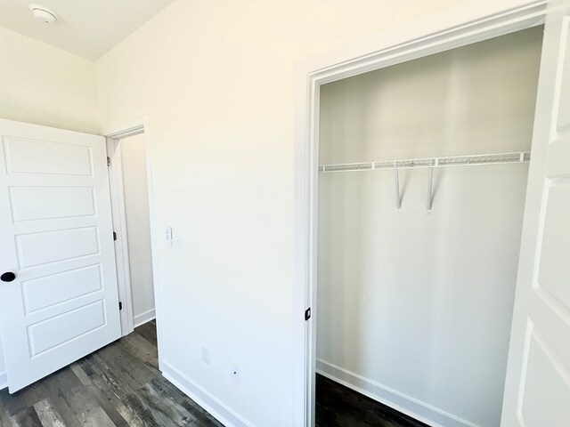 37734 Blue Crab Cir, Painter, VA 23420 - unfurnished bedroom featuring a closet, dark wood-style floors, and baseboards