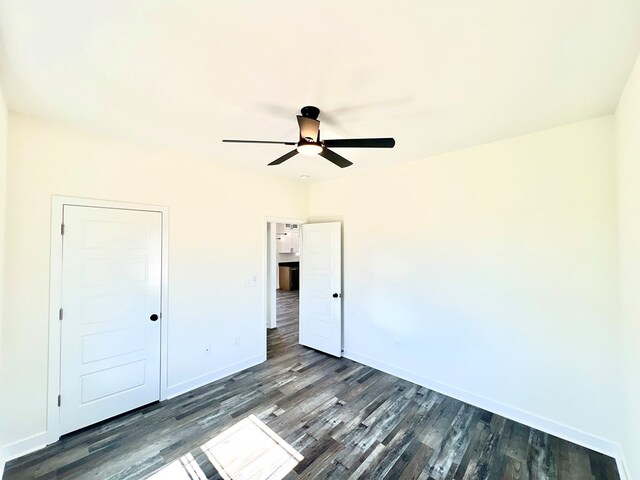 37734 Blue Crab Cir, Painter, VA 23420 - unfurnished bedroom featuring baseboards, dark wood-style flooring, and a ceiling fan