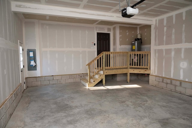 garage featuring a garage door opener and water heater