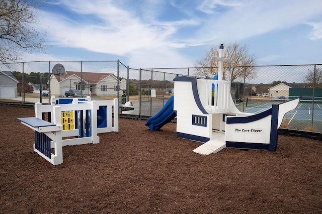 community play area featuring a residential view and fence