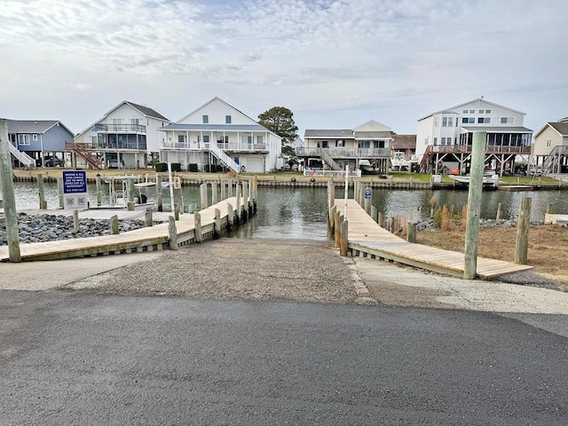 dock area featuring a water view and a residential view