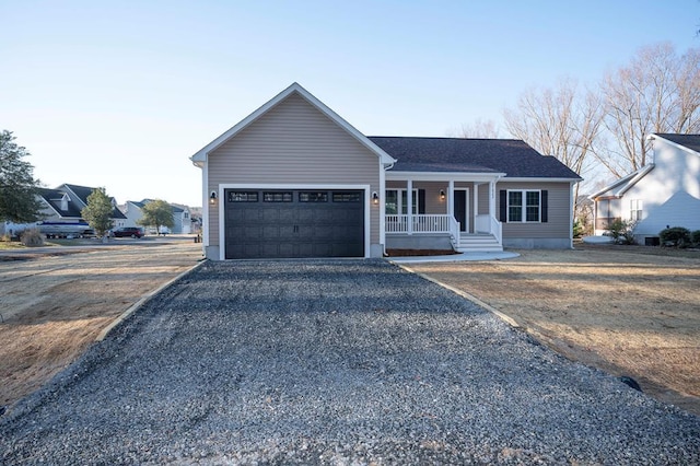 single story home with a porch, driveway, and an attached garage