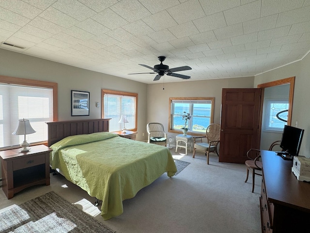 3196 Main St, Chincoteague, VA 23336 - carpeted bedroom featuring a ceiling fan, visible vents, and multiple windows