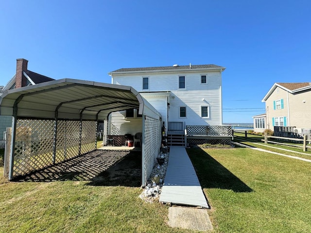 back of property featuring a carport and a yard