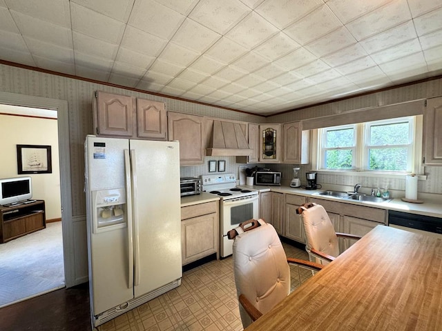 kitchen featuring light brown cabinetry, sink, white appliances, and custom exhaust hood