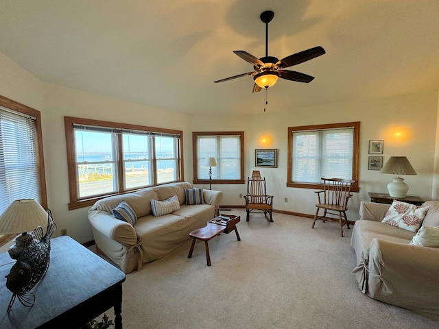 carpeted living room with ceiling fan