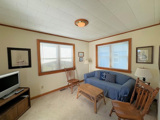 carpeted living room with ornamental molding