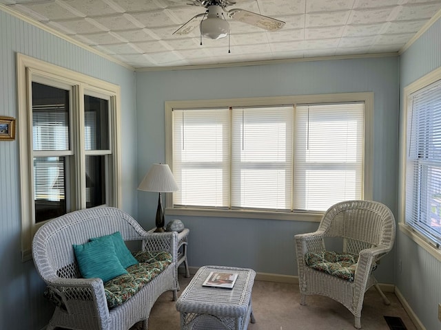 sitting room featuring crown molding, carpet floors, and ceiling fan